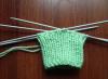 We knit booties for newborns with knitting needles together